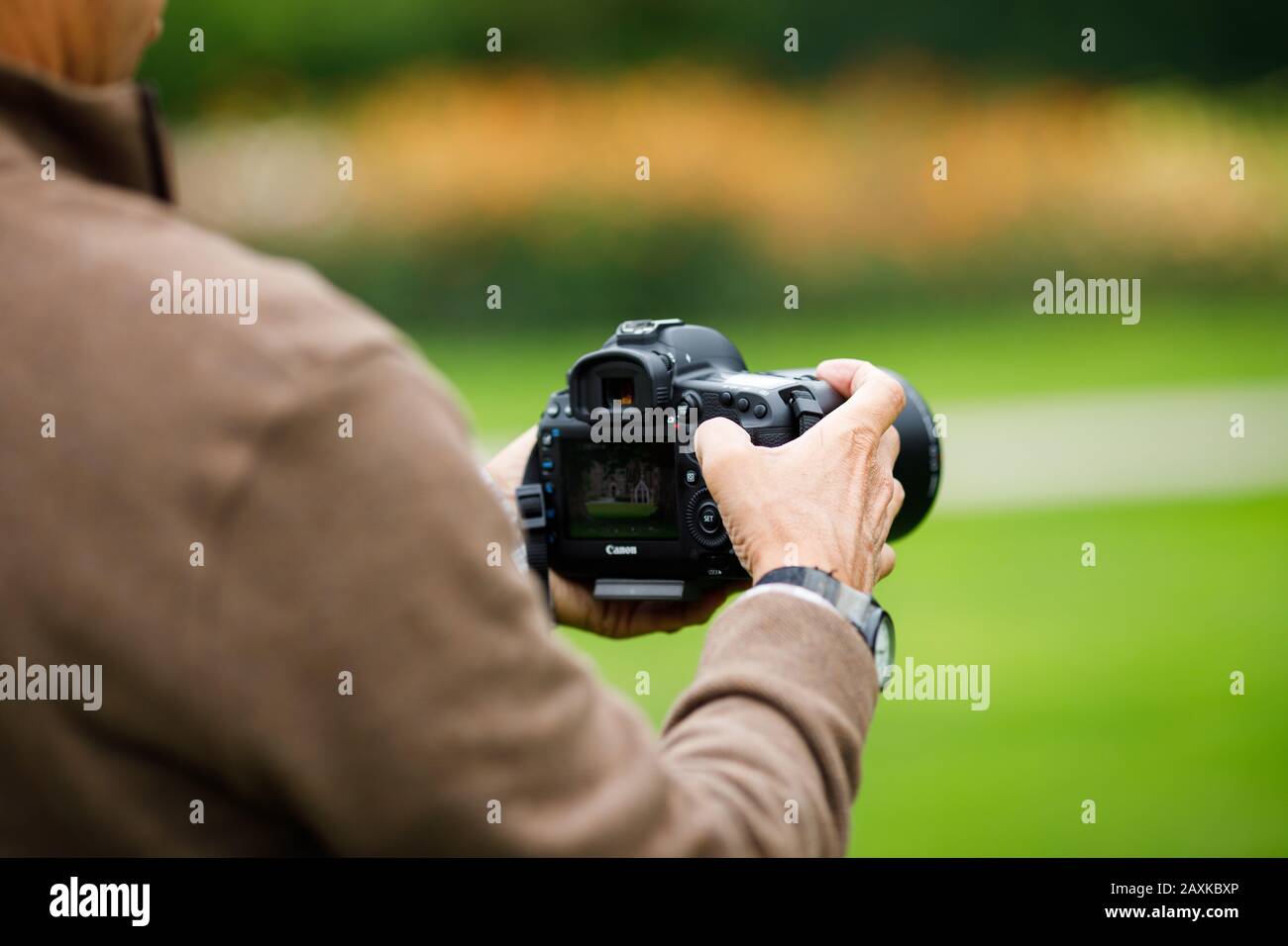 Middle aged man using professional camera Stock Photo