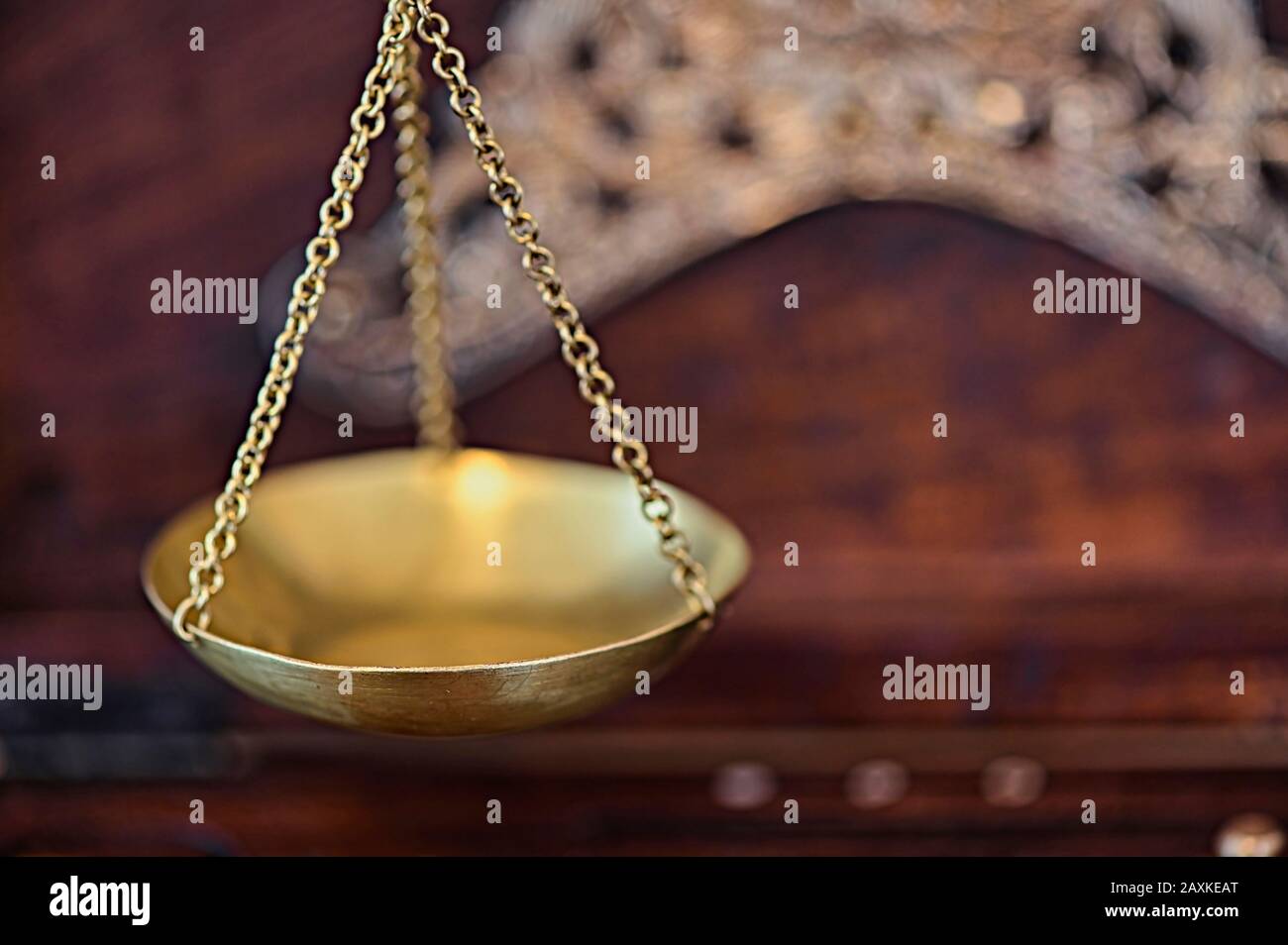 Close-up of an old gold scale with various decorations in a wooden box for storage. Stock Photo