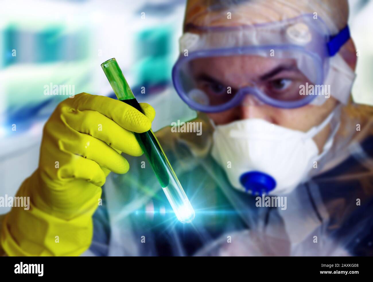 A scientist in a protective suit watching and analyzing the process in a test tube. Concept of innovation, research, science, virus, biology, chemistr Stock Photo