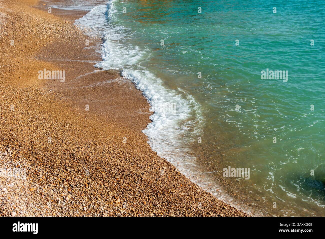 Waves reaching sea shore sunny hi-res stock photography and images - Alamy