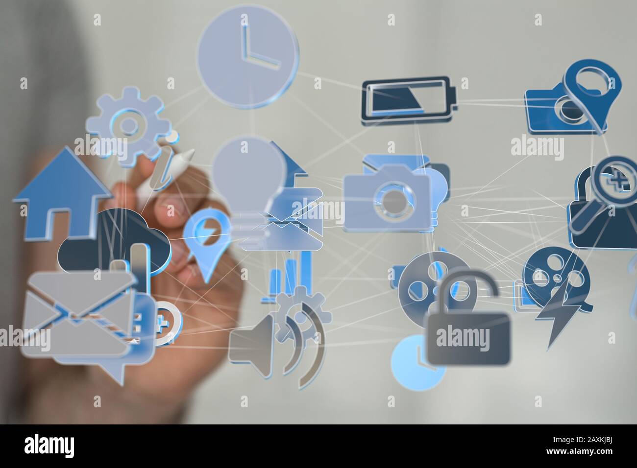 Businessman pressing a virtual projection of different icons connected with cloud Stock Photo