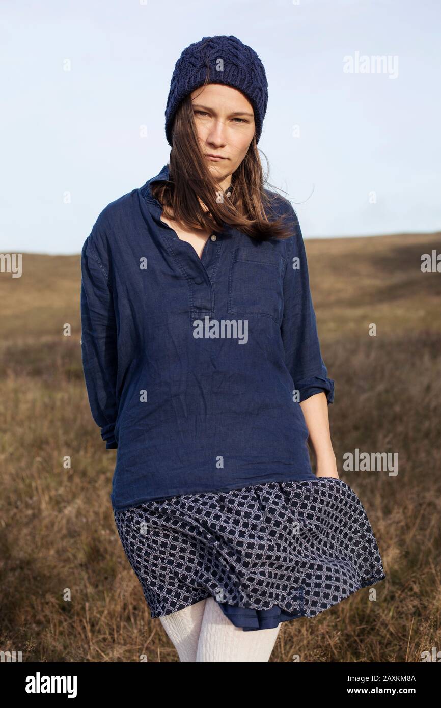 Outdoor portrait of a young serious woman in autumn Stock Photo