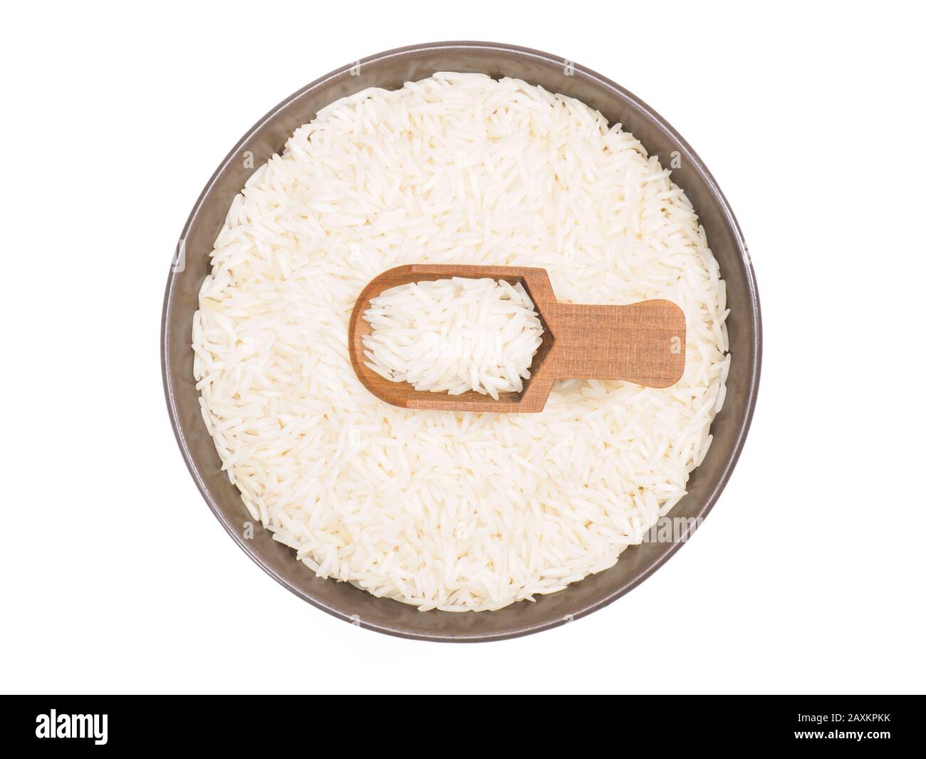 Indian long grain Basmati rice in brown ceramic bowl and scoop isolated on white. Indian cuisine