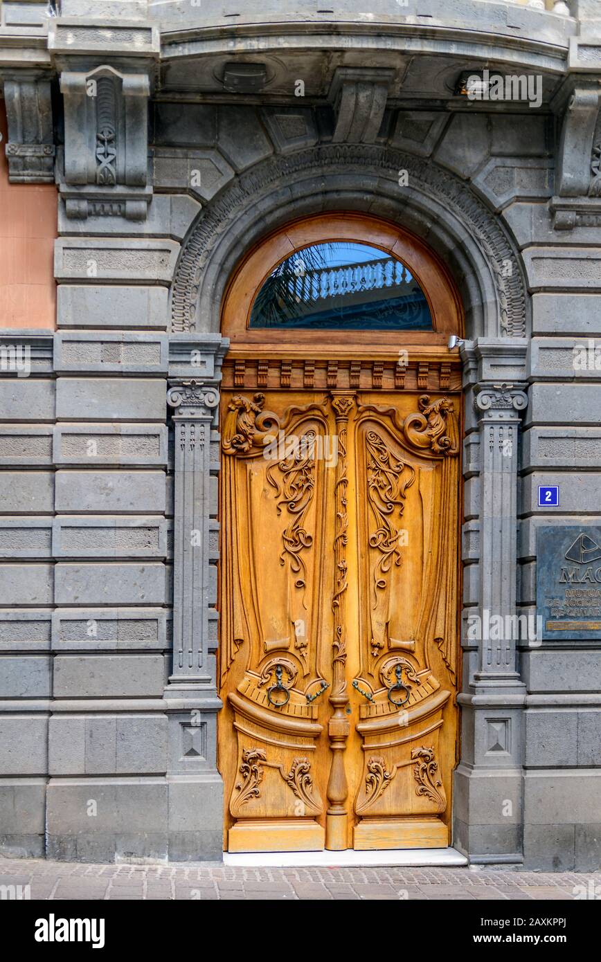 A traditional ornate carved wood wooden Spanish door, Santa Cruz, Tenerife, Canary Islands. Stock Photo
