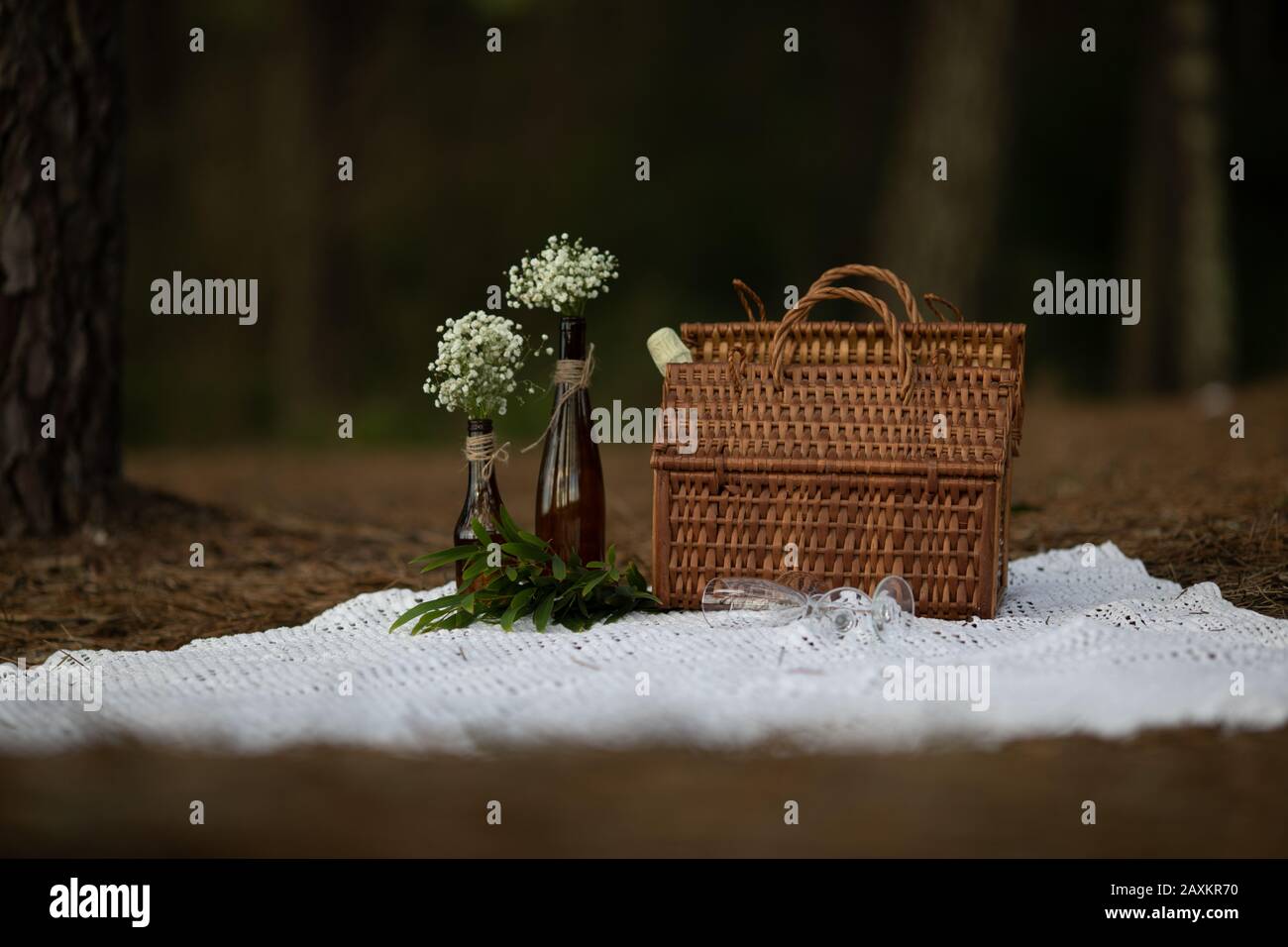 wicker picnic basket in the forest with autumn tones over a vintage