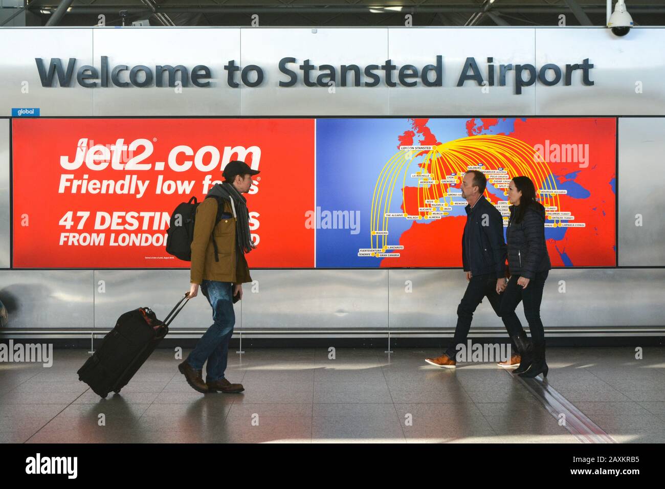 London Stansted Airport STN, United Kingdom UK,  Welcome sign at the entrance of the Airoprt Travellers with trolleys and passengers walking. Brexit Stock Photo