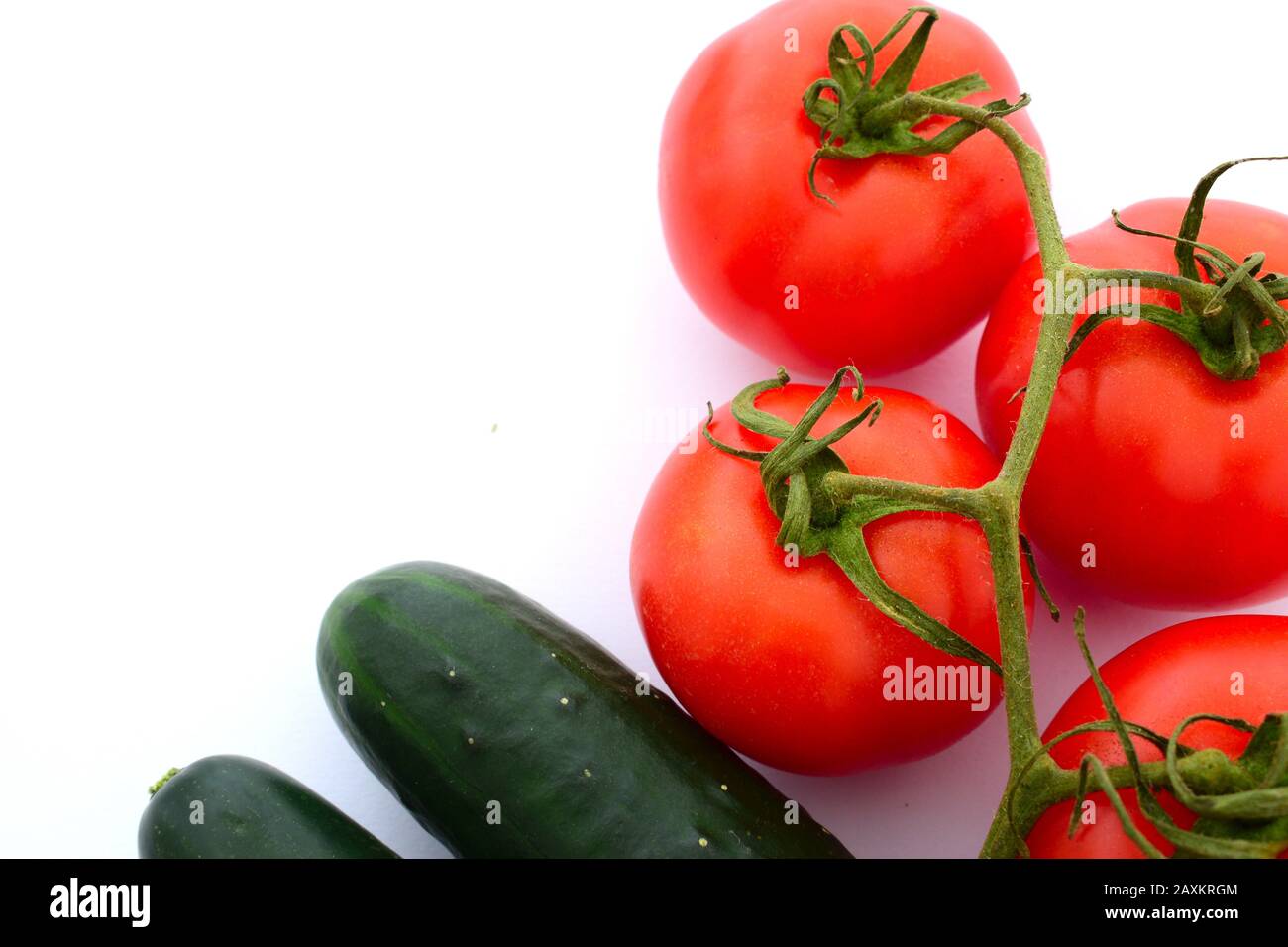 Tomatoes and cucumbers on a completely white background Stock Photo