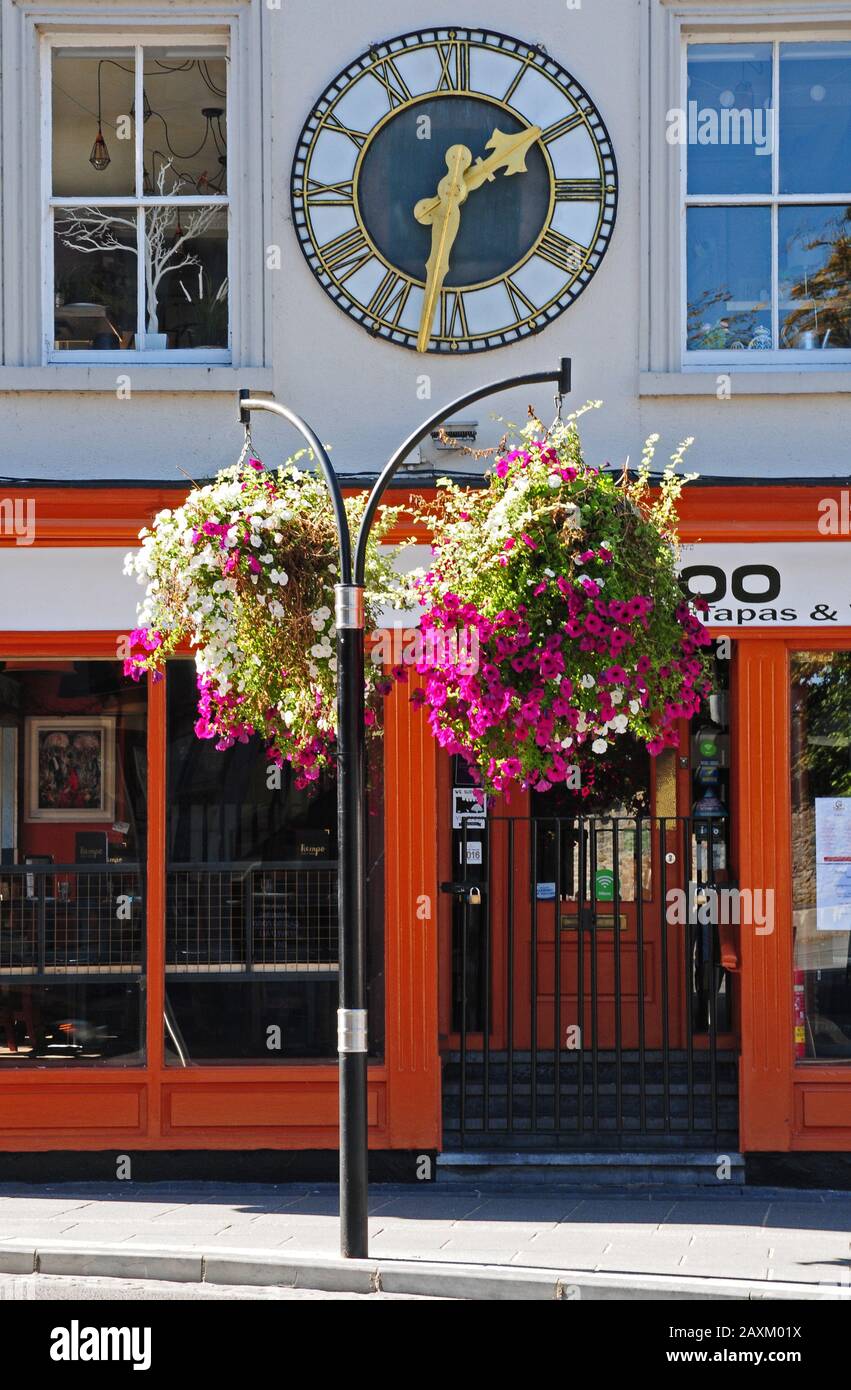 Large clock on the outside wall of a restaurant, in Kilkenny. Stock Photo