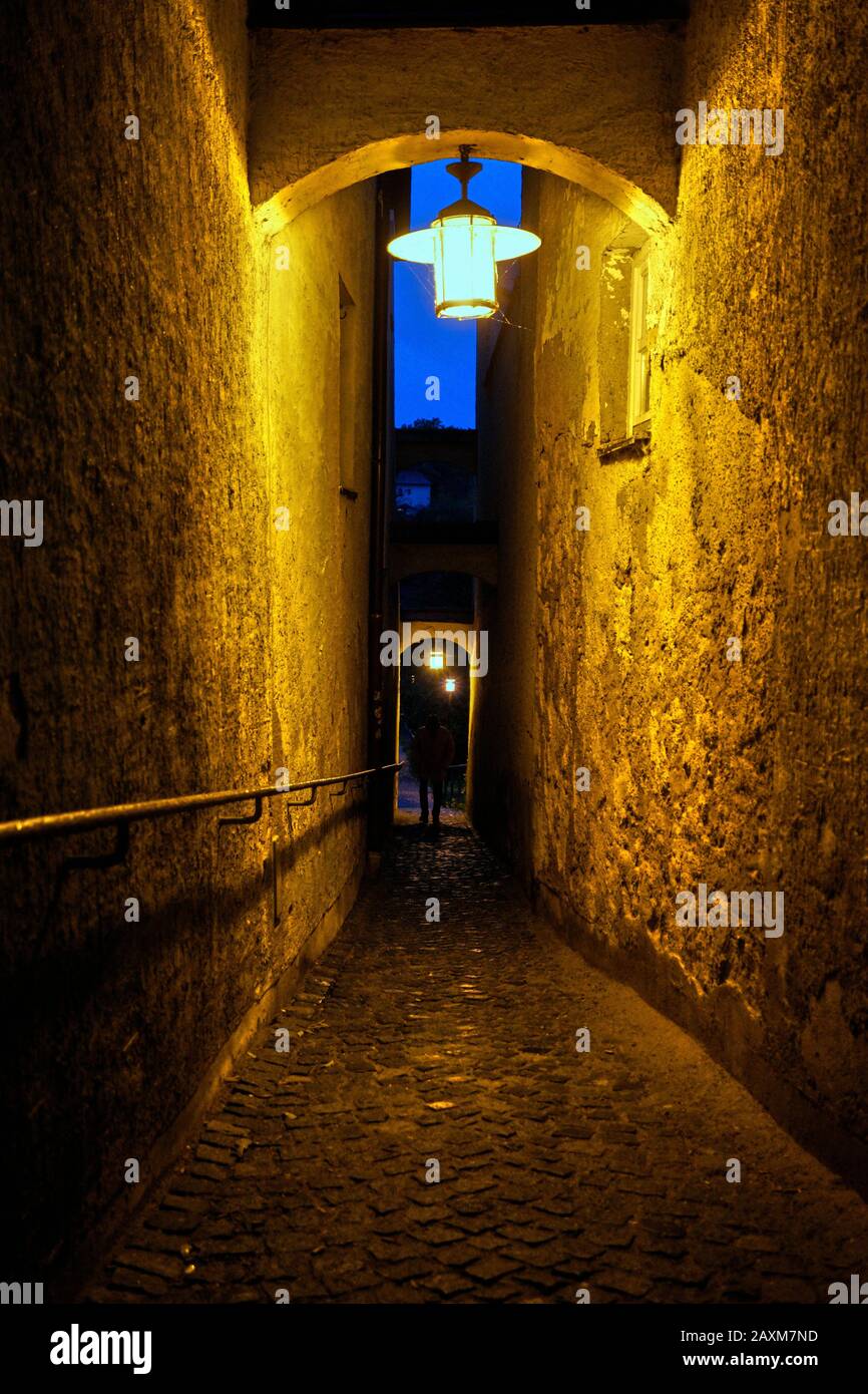 Germany, Bavaria, Upper Bavaria, Neuötting, narrow lane, in the evening, lantern, dim, dark Stock Photo