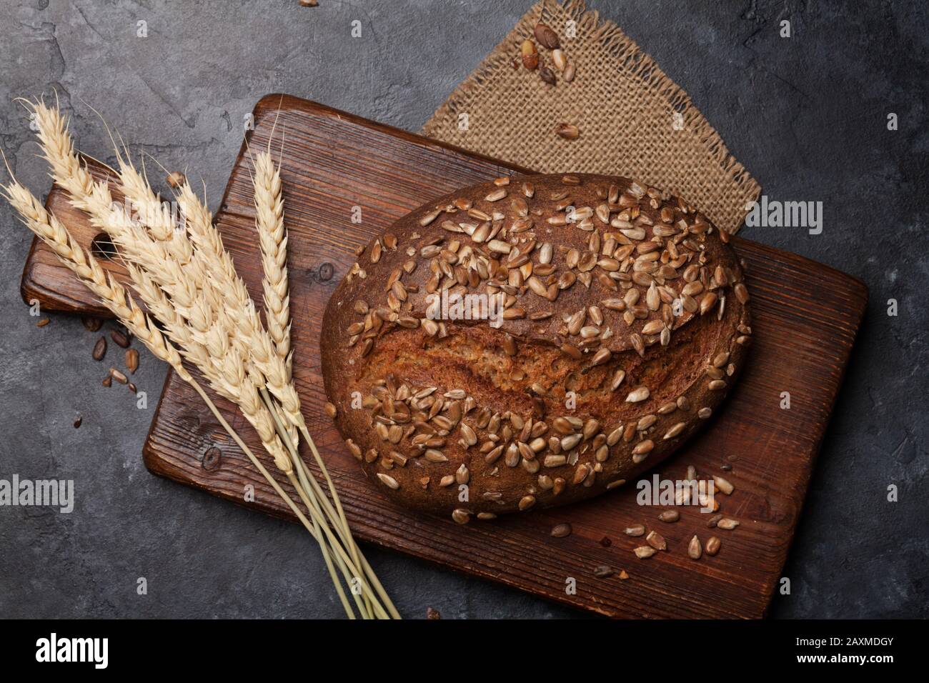 https://c8.alamy.com/comp/2AXMDGY/homemade-bread-with-seeds-on-stone-table-top-view-flat-lay-2AXMDGY.jpg