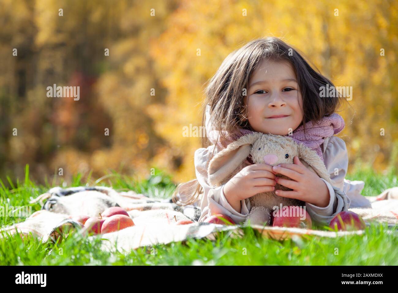 Cute Little Girl On Autumn Picnic Baby Hold Fruit And Teddy Bunny On Background Of Gold Forest Toddler Eating Fruits At Harvest Outdoor Fun For Chi Stock Photo Alamy