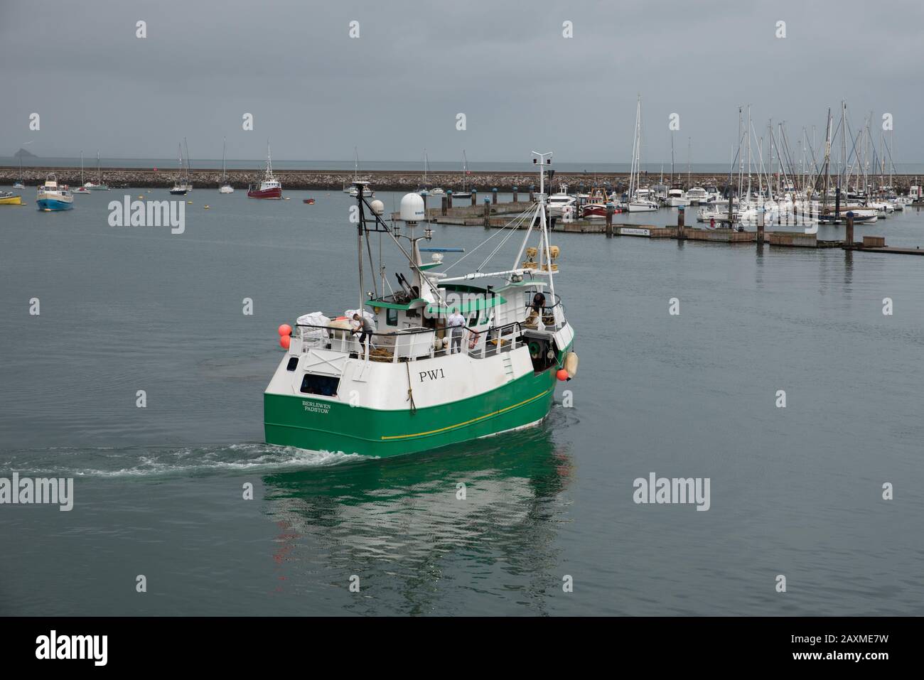 A fishing boat leaving Brixham harbour, one of Great Britain's largest fishing port. Stock Photo