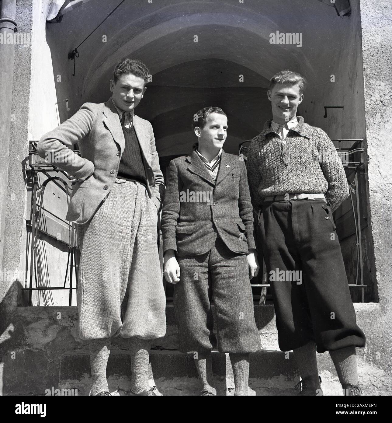 Late 1930s, historical picture of three young men in the fashionable male clothing of the era, woollen plus fours. Also known as breeches, the trousers extended a few inches below the knee and could be worn with either a jacket or sweater. Stock Photo