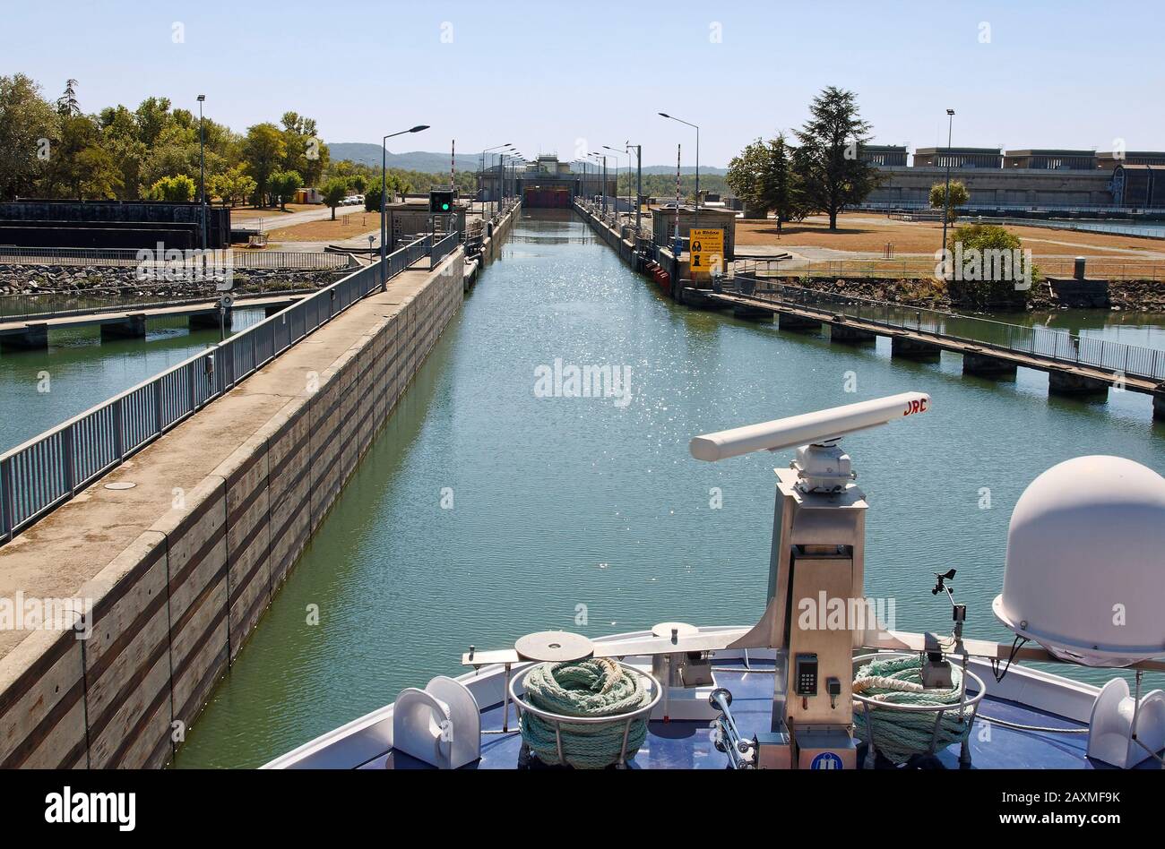 Bollene Lock, riverboat approaching, Rhone River, 71 foot difference, navigable, waterway technology, marine, Provence, France, summer, horizontal Stock Photo