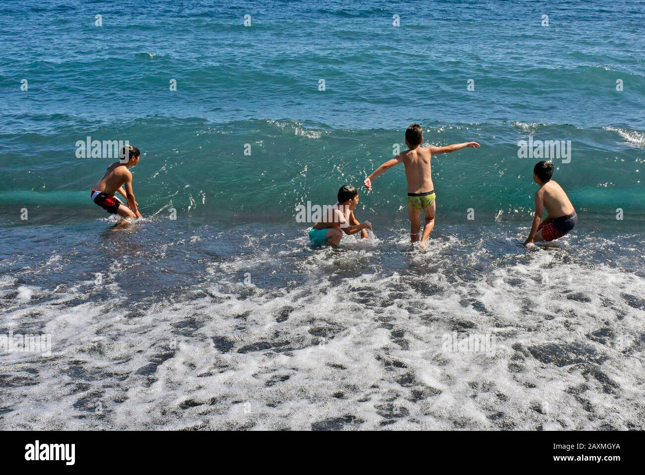Children bathing in Lake Llanquihue, Chile Stock Photo