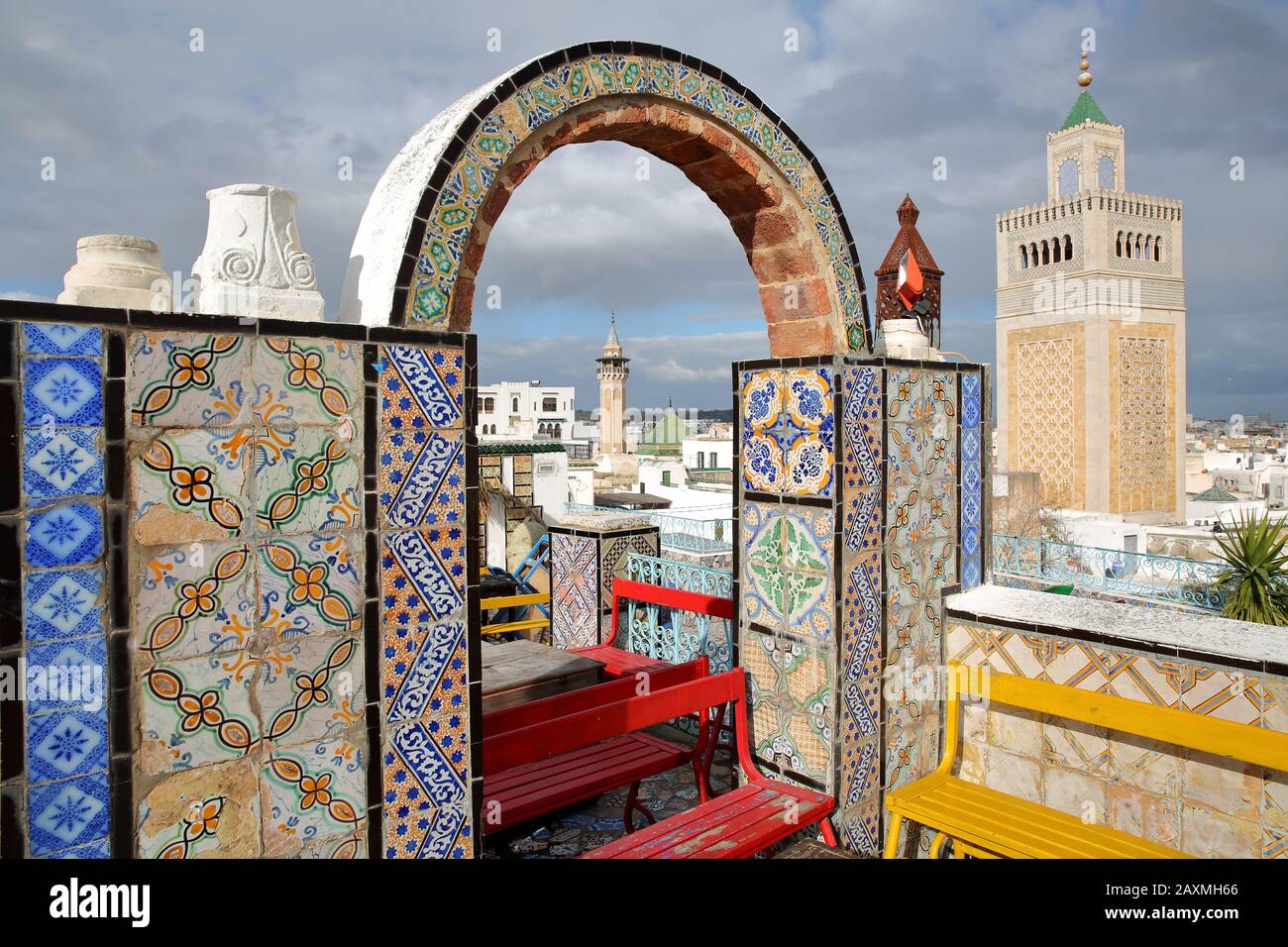Colorful tiled terrace overlooking the medina in Tunis, Tunisia, with a view on the minaret of Ez Zitouna Mosque (Great Mosque) and the minaret of Ham Stock Photo