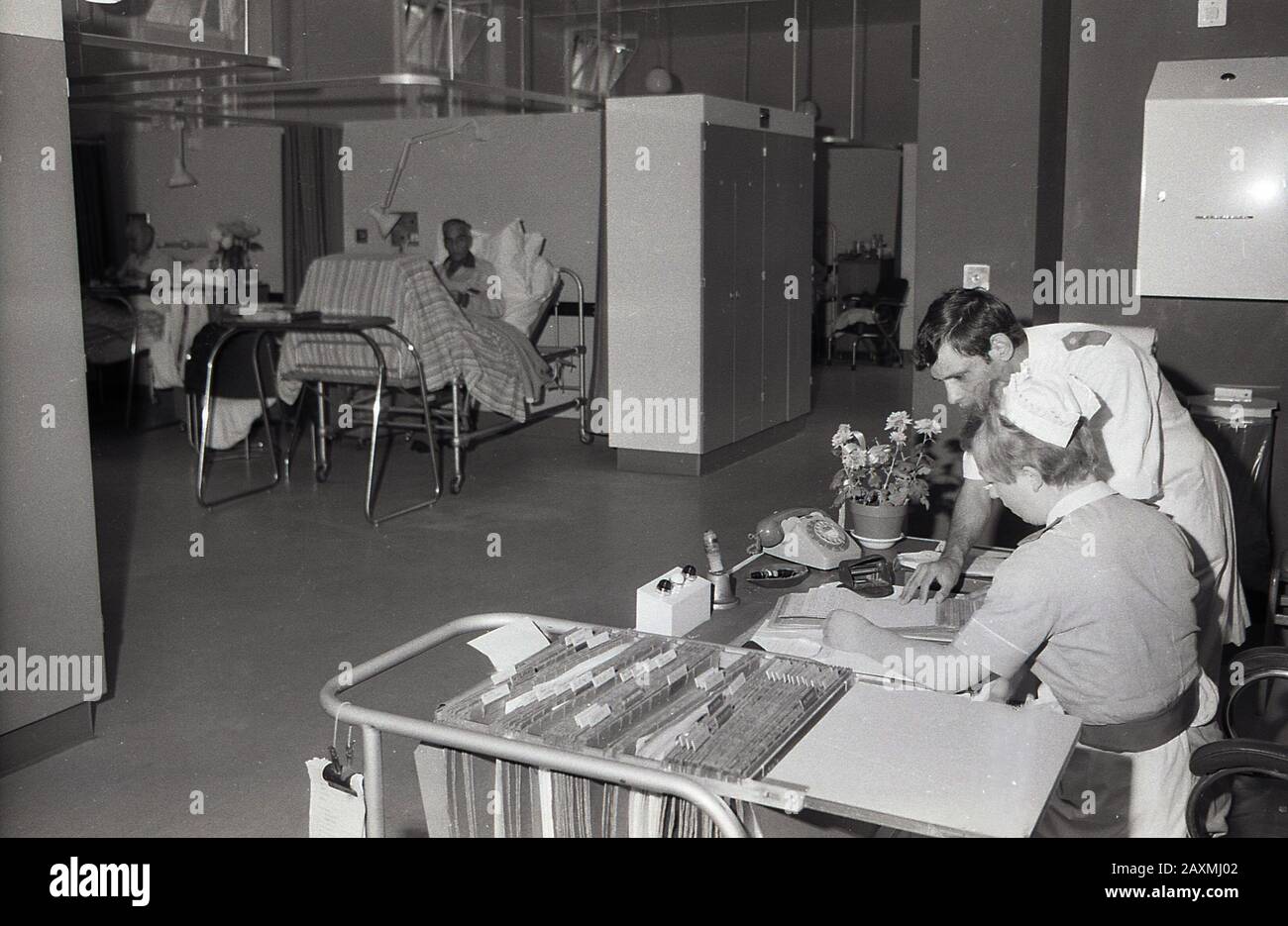 1960s, historical, a male and female nurse at a desk in a hospital ward looking at patients medical notes, Brook General Hospital, Southeast London, England, UK. Built in 1896 as a fever hospital it became a general hospital in the 1950s. Stock Photo