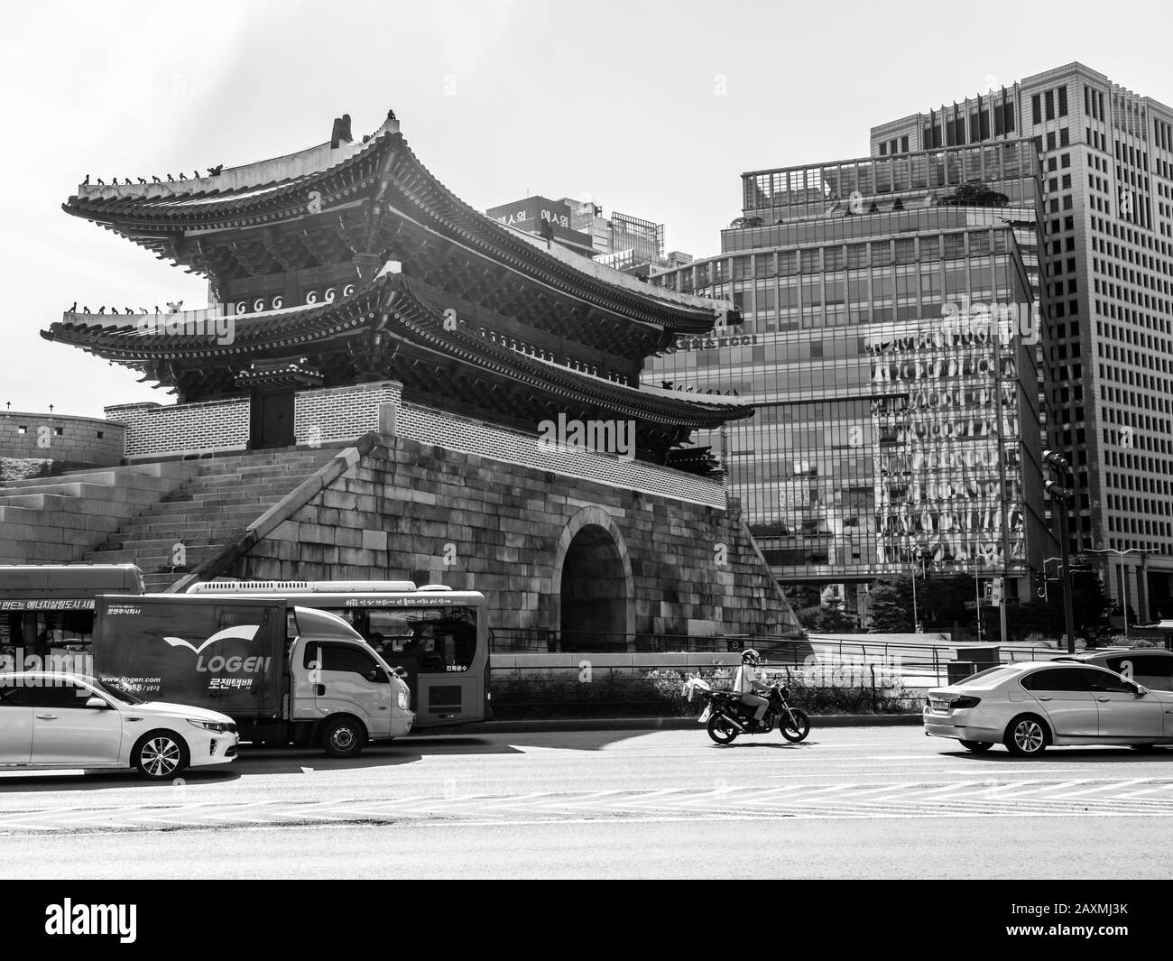 Seoul, South Korea - June 3, 2017: Man riding a motorbike among cars on the downtown in Seoul. Stock Photo