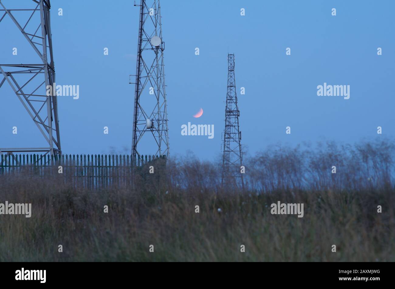 Partial Lunar Eclipse at dusk Stock Photo