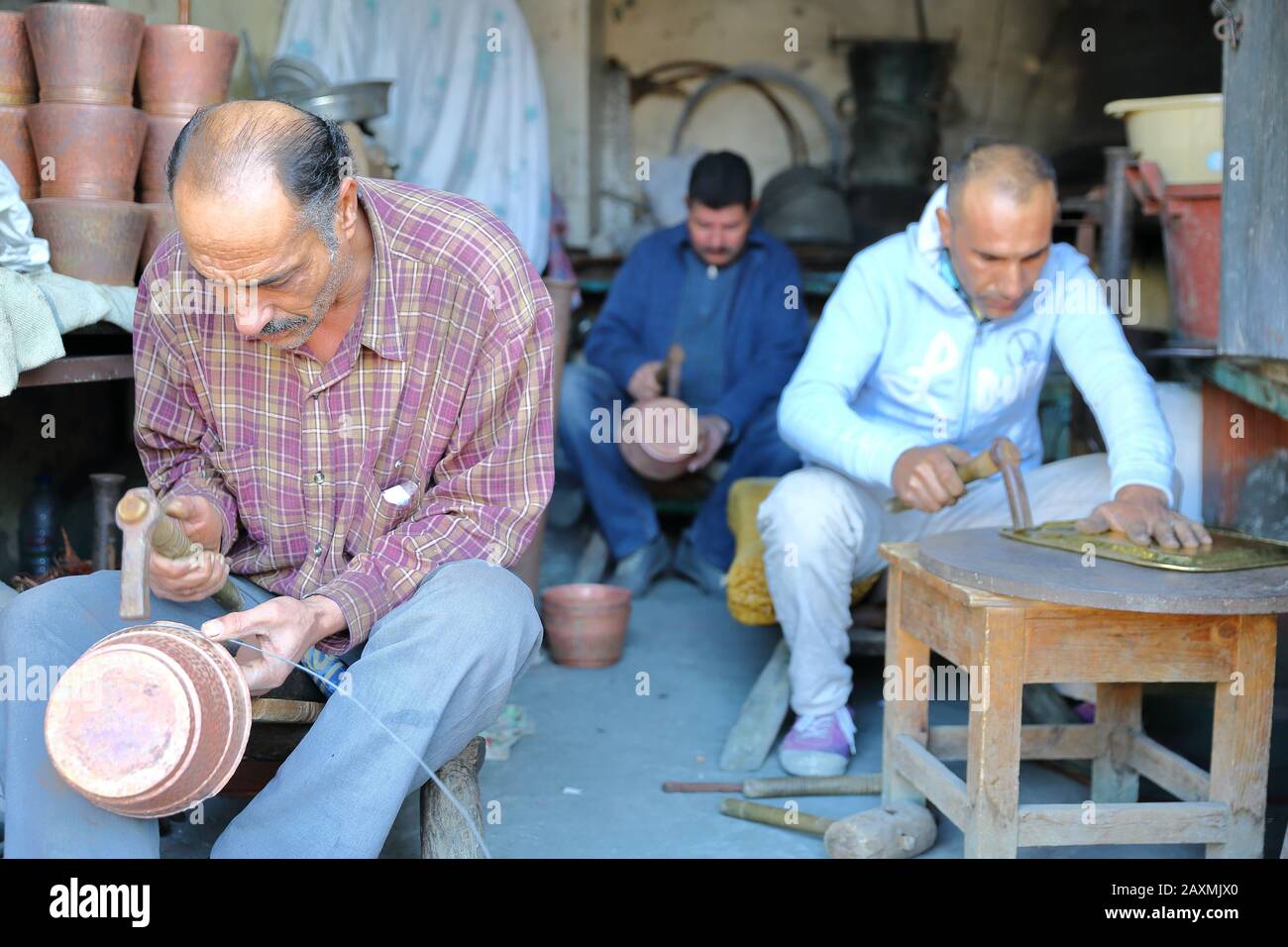 KAIROUAN, TUNISIA - DECEMBER 10, 2019: Brass and copper craftsmen at work (El Moez Ibn Badis avenue) Stock Photo