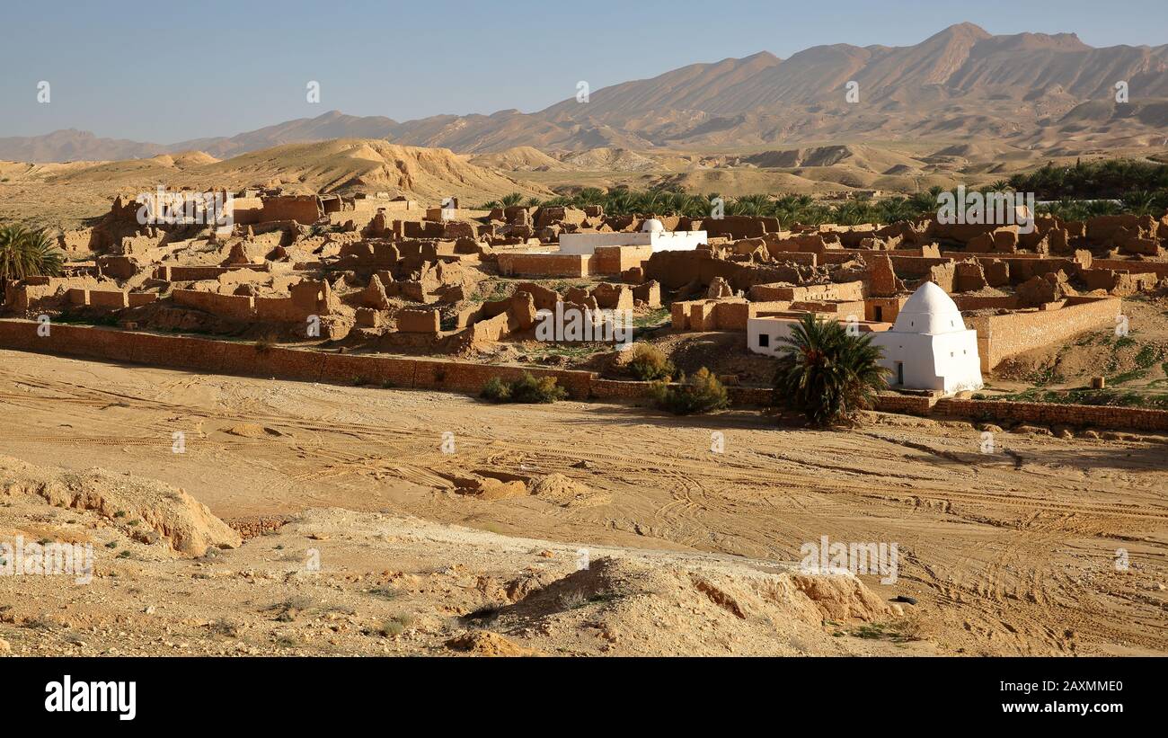 The ruins of the abandoned village of Tamerza near Nefta, Tunisia, with a desert landscape Stock Photo