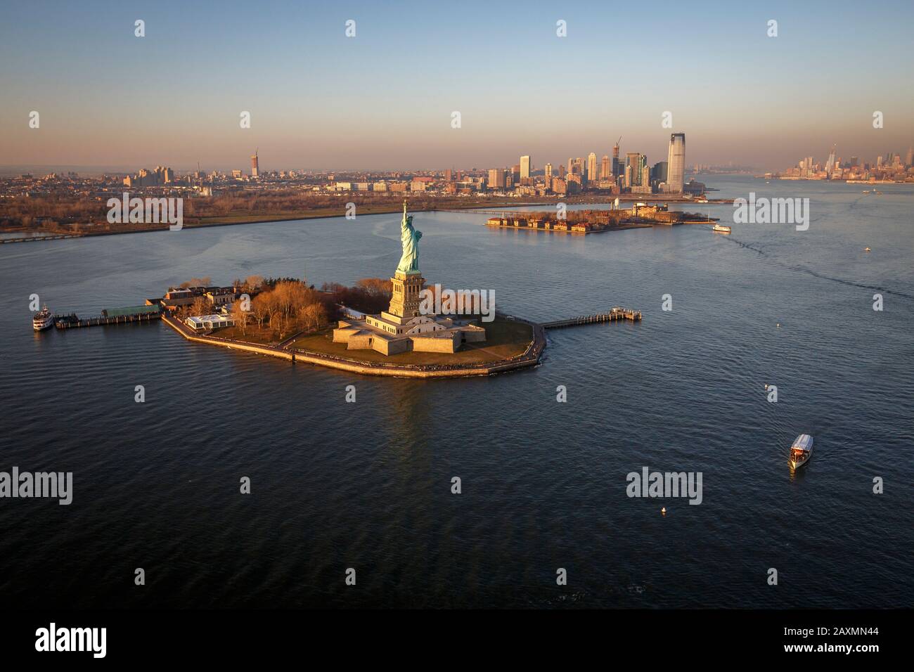 The Statue of Liberty stands tall over New York Harbor, NYC Stock Photo