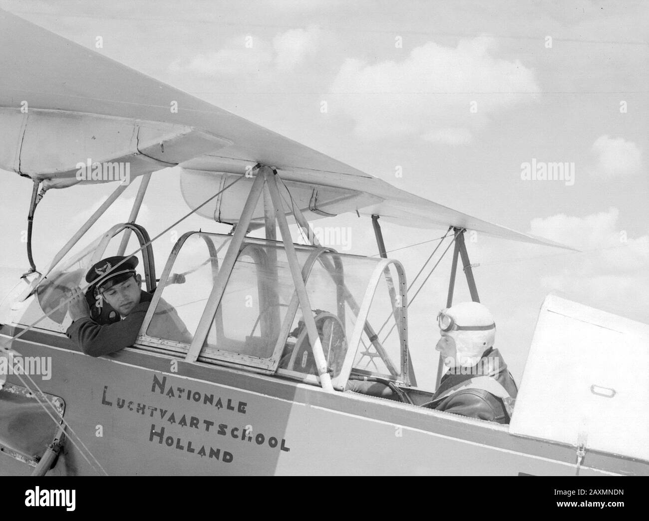 Nationaal Aviation School Holland   A Koolhoven FK-46 class plane by his dociele flying behaviour nicknamed 'Cow of Koebeest' of the National Aviation School Holland in Amsterdam Schiphol with instructor and trainee. Annotation: The National Aviation School had branches in Rotterdam Waalhaven and Amsterdam Schiphol Date: 1933 Location: Amsterdam, Rotterdam Keywords: pupils, teachers, pilots, flight training, aircraft Personal name: Frits Koolhoven Stock Photo