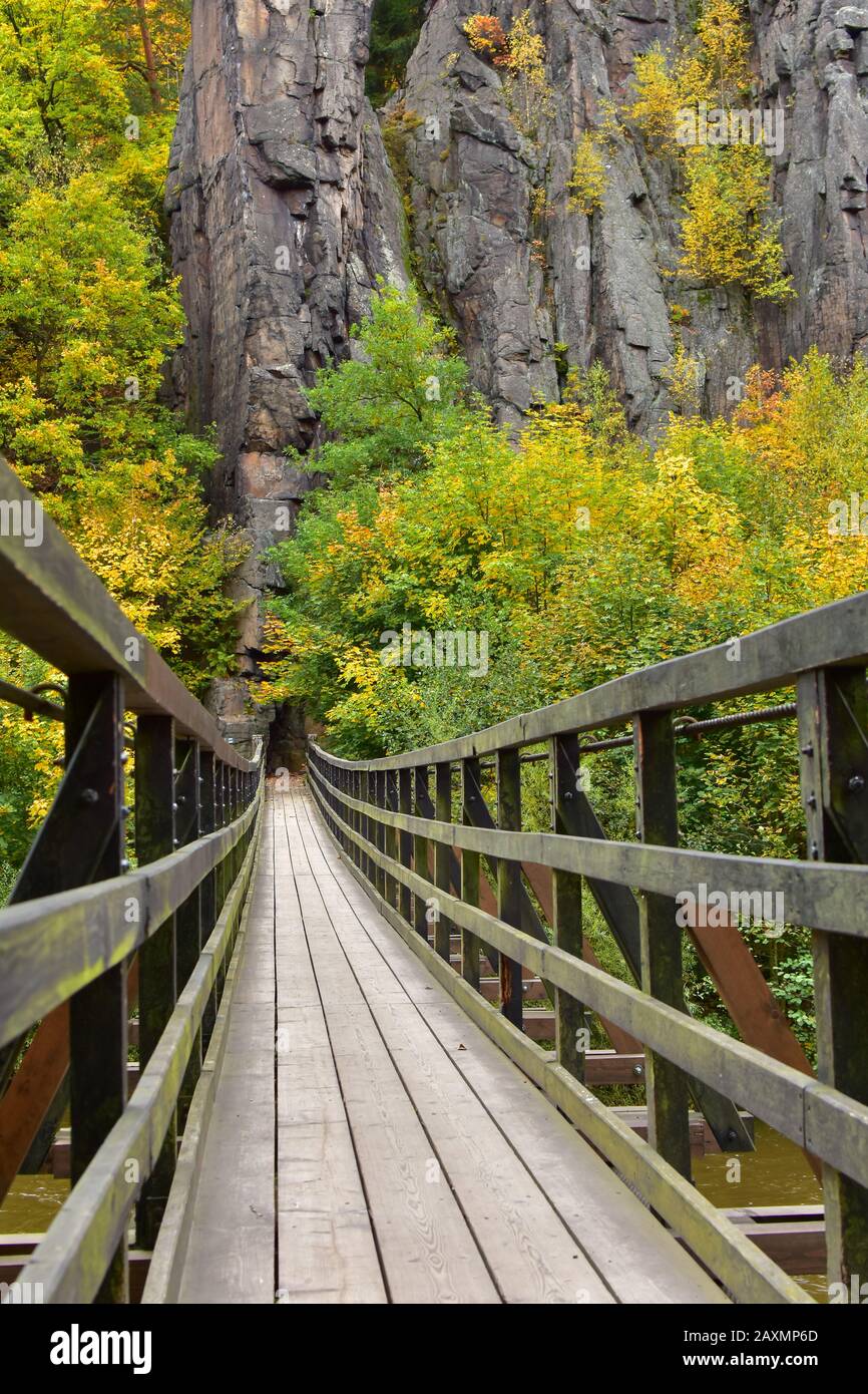 Old wooden bridge in a national park in the Czech Republic. Vertical photo was taken in autumn. Stock Photo