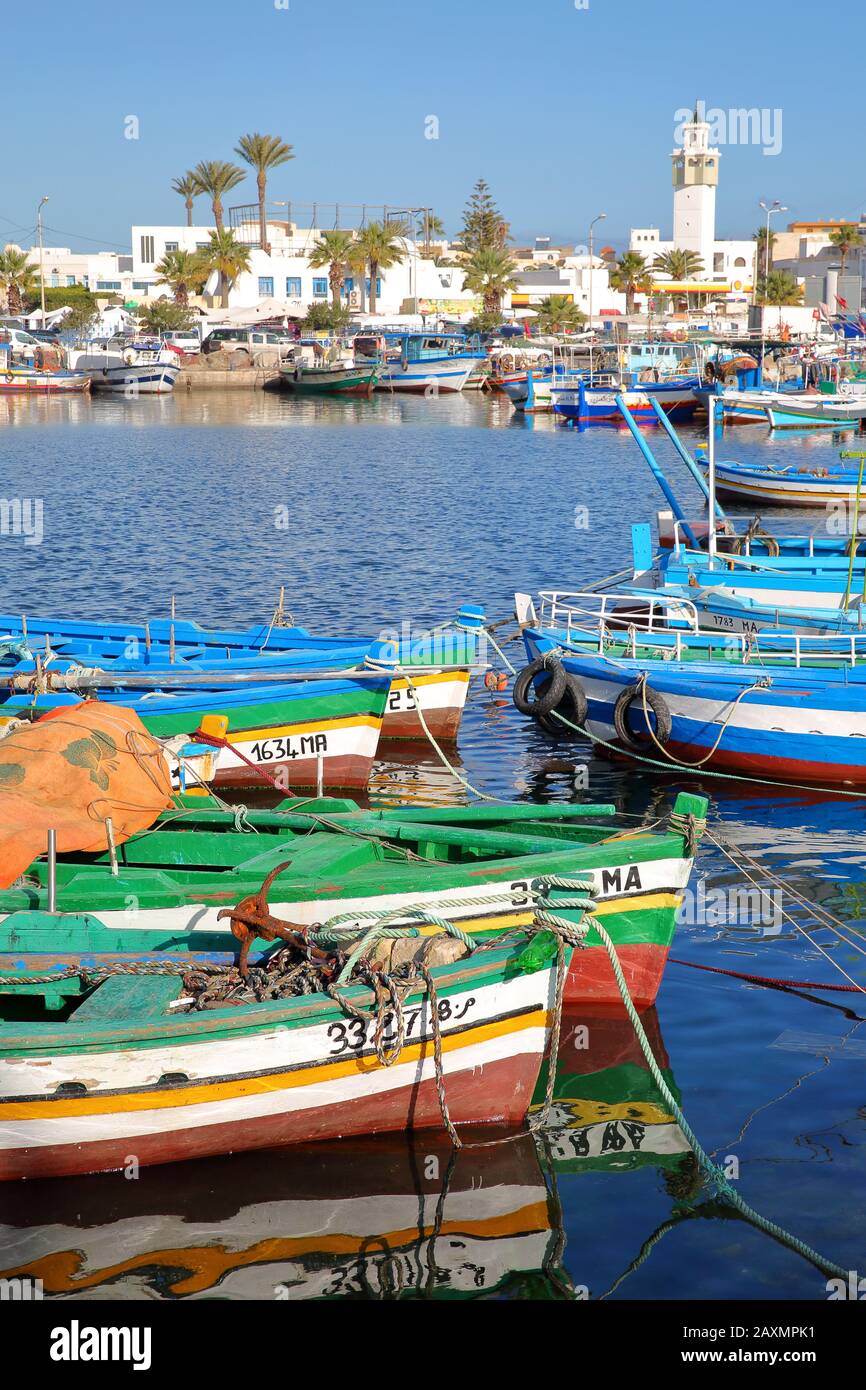 MAHDIA, TUNISIA - DECEMBER 27, 2019: The fishing port with colorful fishing  boats and the city of Mahdia in the background Stock Photo - Alamy