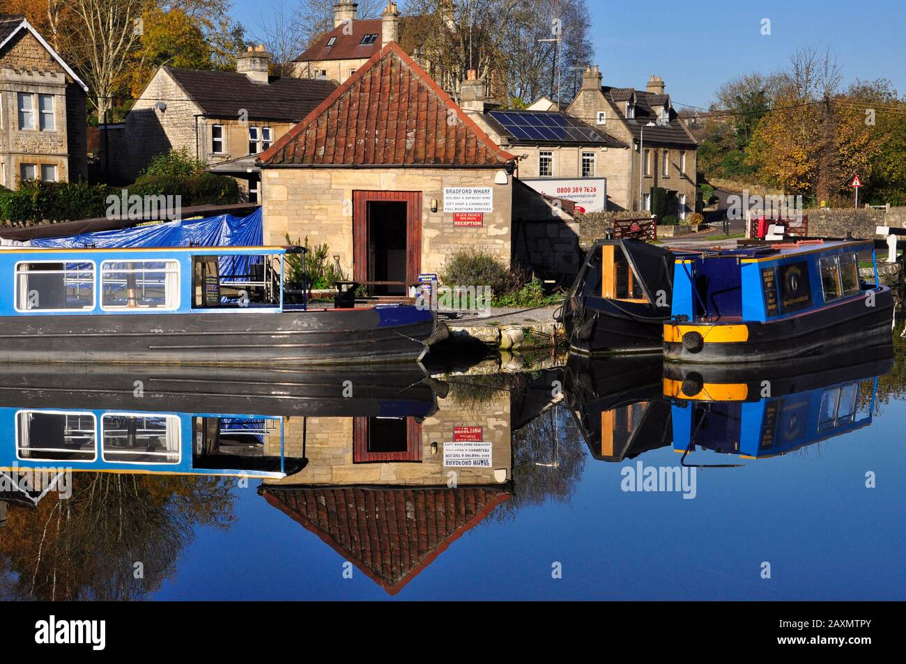 Reflections in the canal basin on a clear autumn day on the Kennet and Avon canal at Bradford on Avon.Wiltshire. England.UK Stock Photo