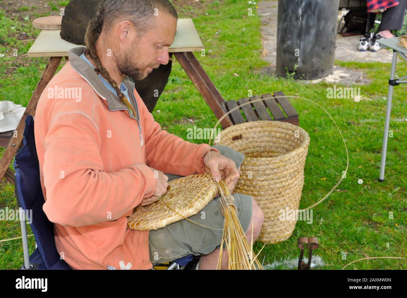 Craftsman weaving a round straw basket lid.Somerset, England,UK Stock Photo