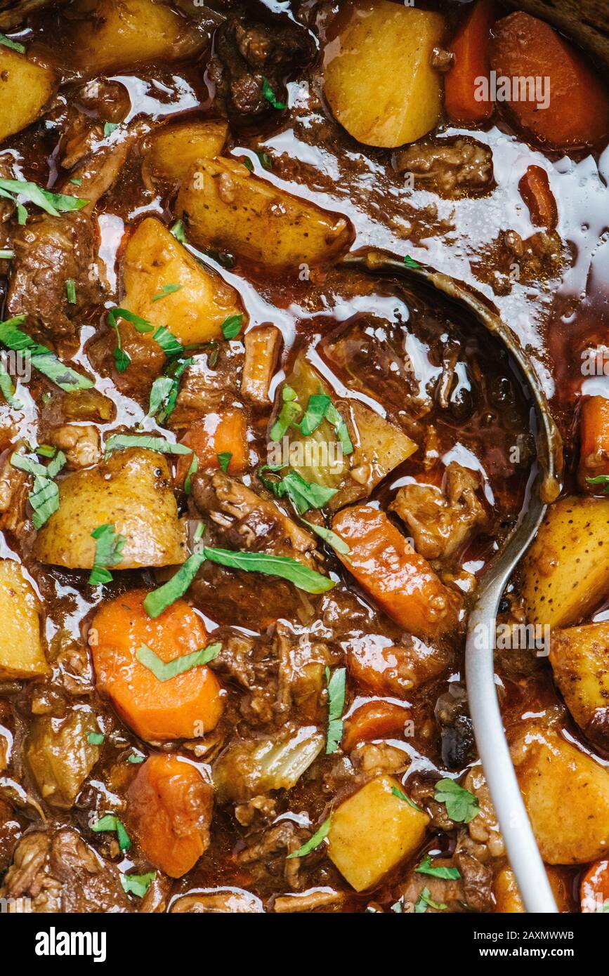 Beef stew closeup with serving spoon Stock Photo Alamy