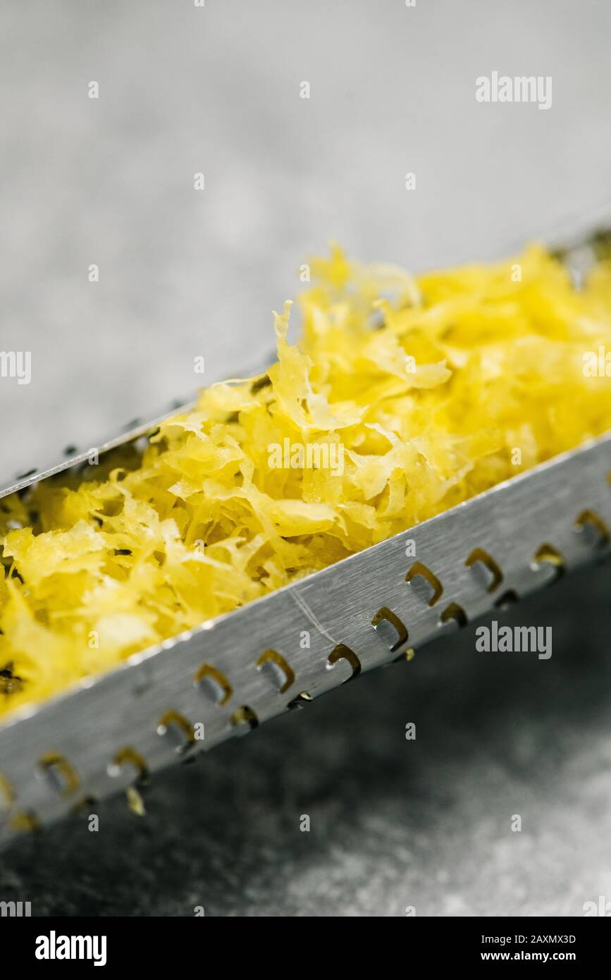 Lemon zest in a zester Stock Photo
