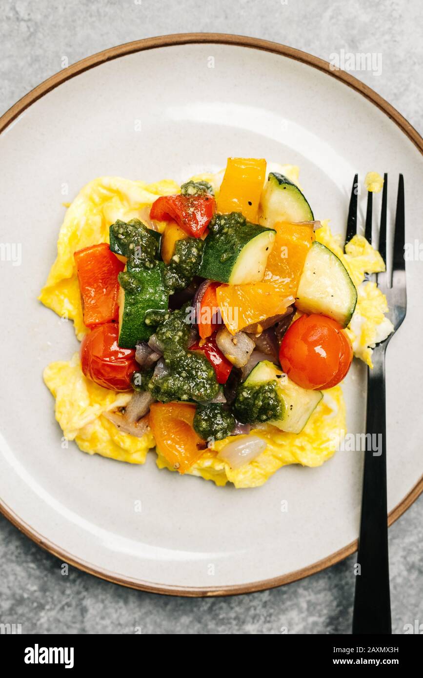 Whole30 vegetable scramble with basil pesto Stock Photo