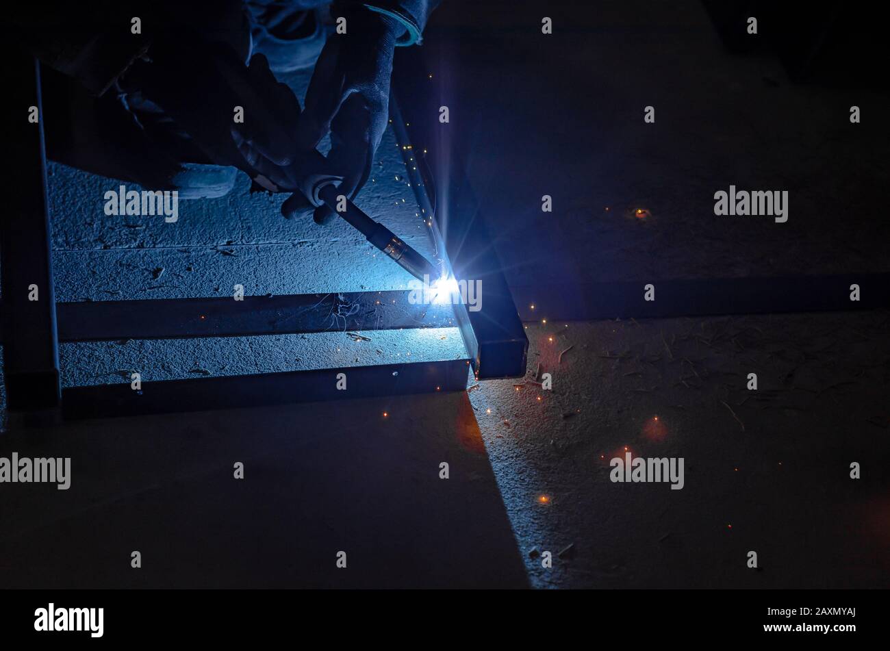 Welding a metal frame in a workshop with argon welding Stock Photo