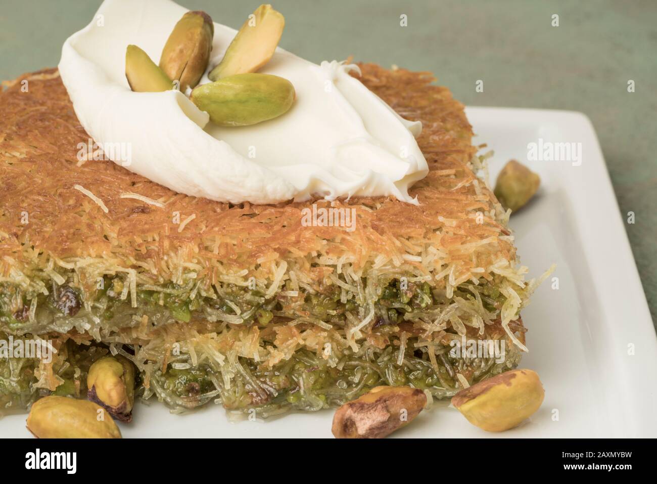 traditional Turkish dessert kadayif with pistachio on table Stock Photo