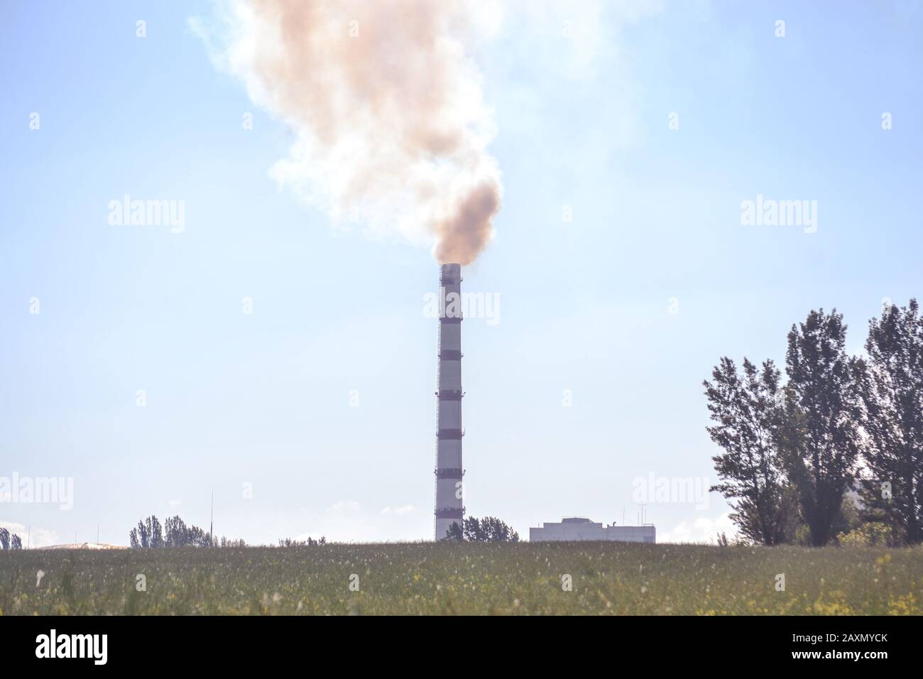 Pipe factory smoke in the field with clear sky Stock Photo