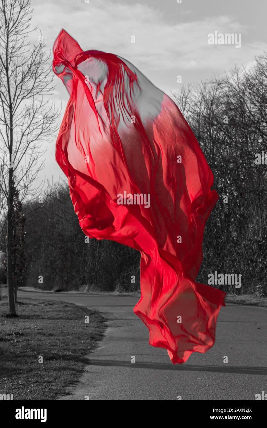A red cloth hovers over a small country road. Stock Photo