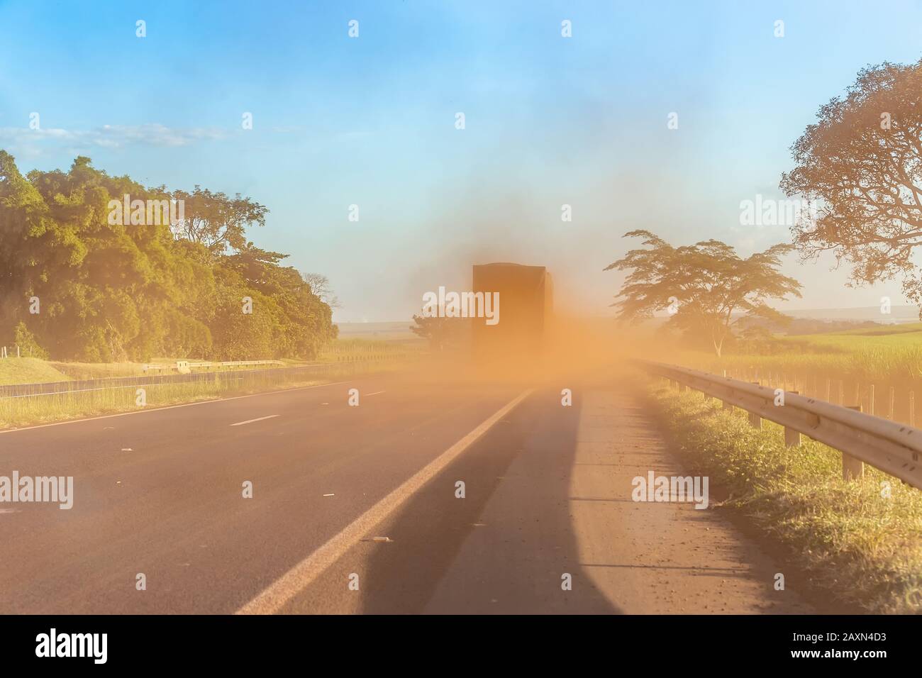 Sugar cane truck on the road with lots of dust Stock Photo