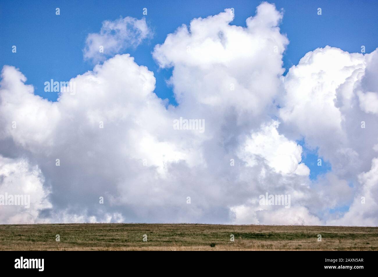 big and large clouds and field with filter Stock Photo