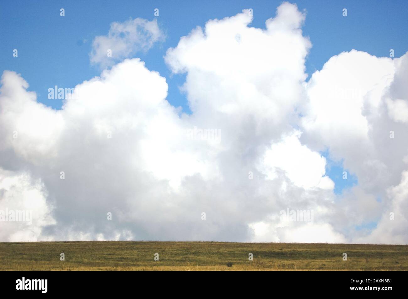 big and large clouds and field with filter Stock Photo