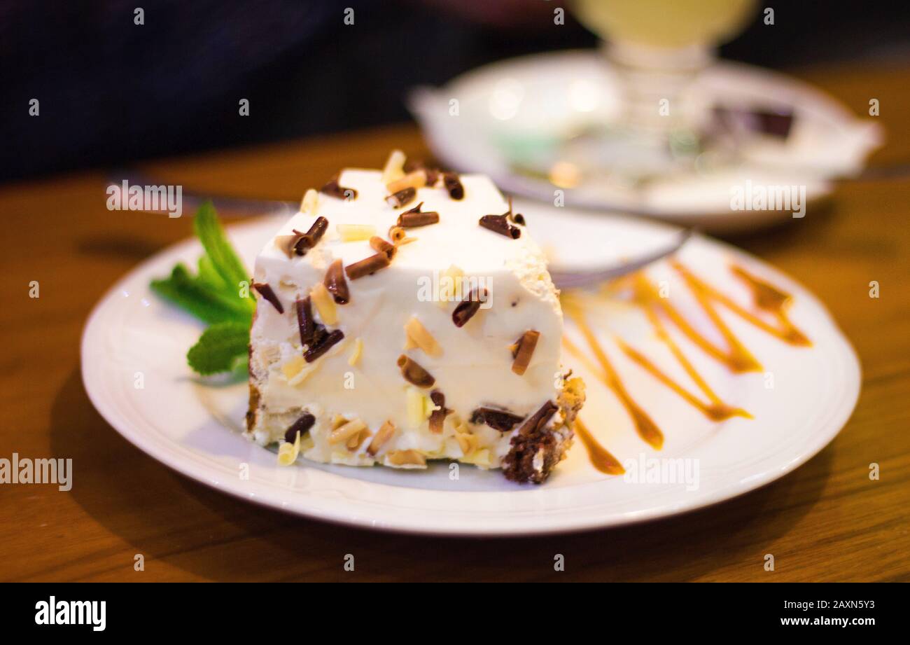 a plate with tasty white cake on the table Stock Photo