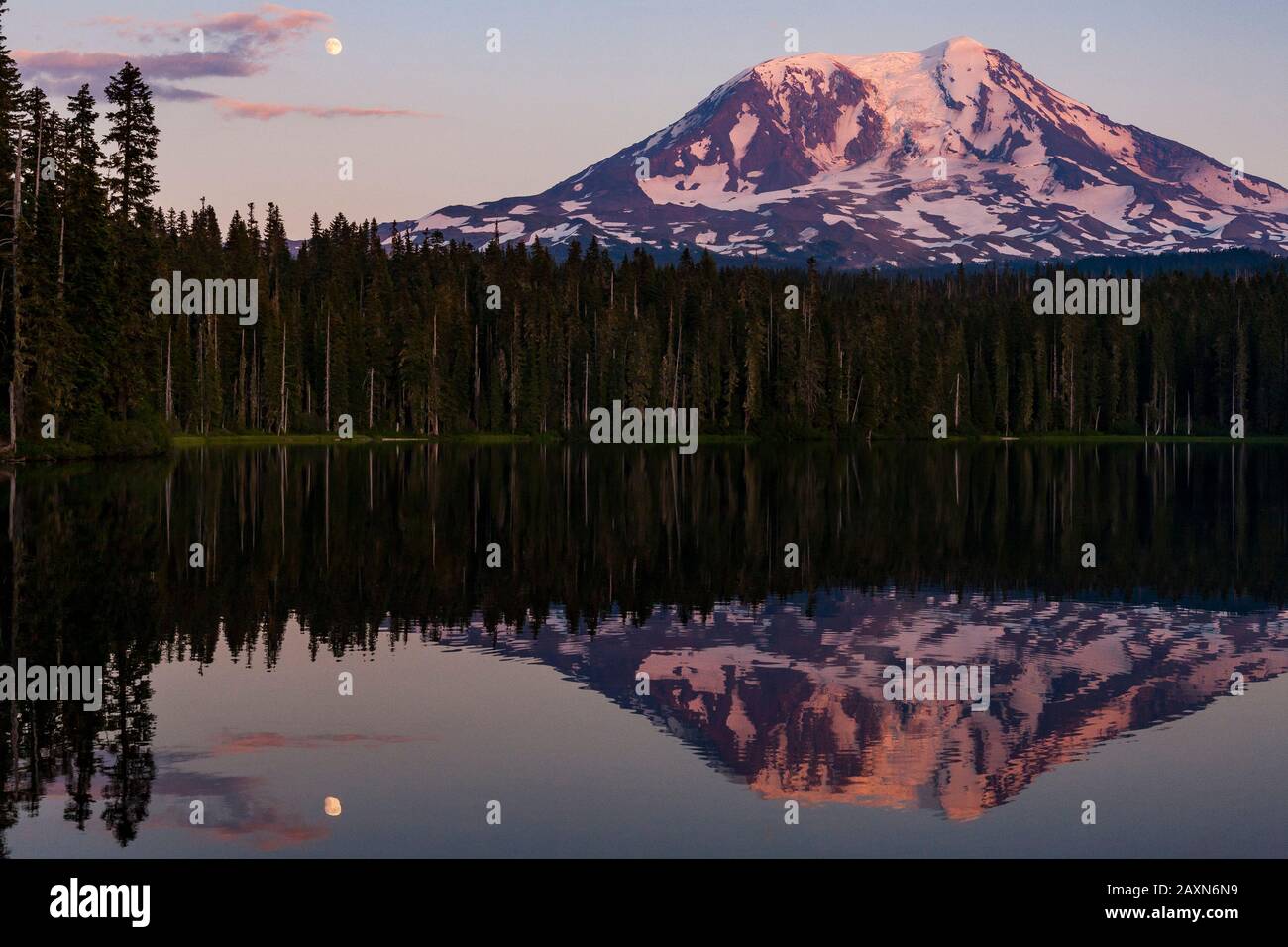Mount Adams is reflected in the water of Takhlakh Lake at sunset while ...