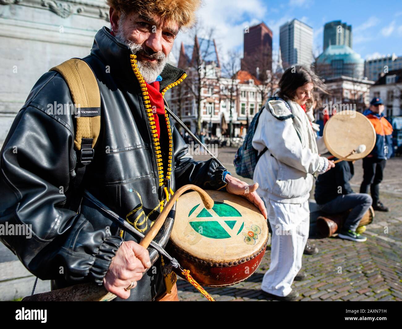 A man playing a drum with the XR logo during the protest.While the Dutch government has a debate about CETA, free trade agreement, the activist group Extinction Rebellion Nederland carried out an action outside of the Houses of Parliament to make a call to stop the CETA agreement. Over 70 organizations worldwide have signed an open letter to call upon the Dutch government to vote against CETA. Stock Photo