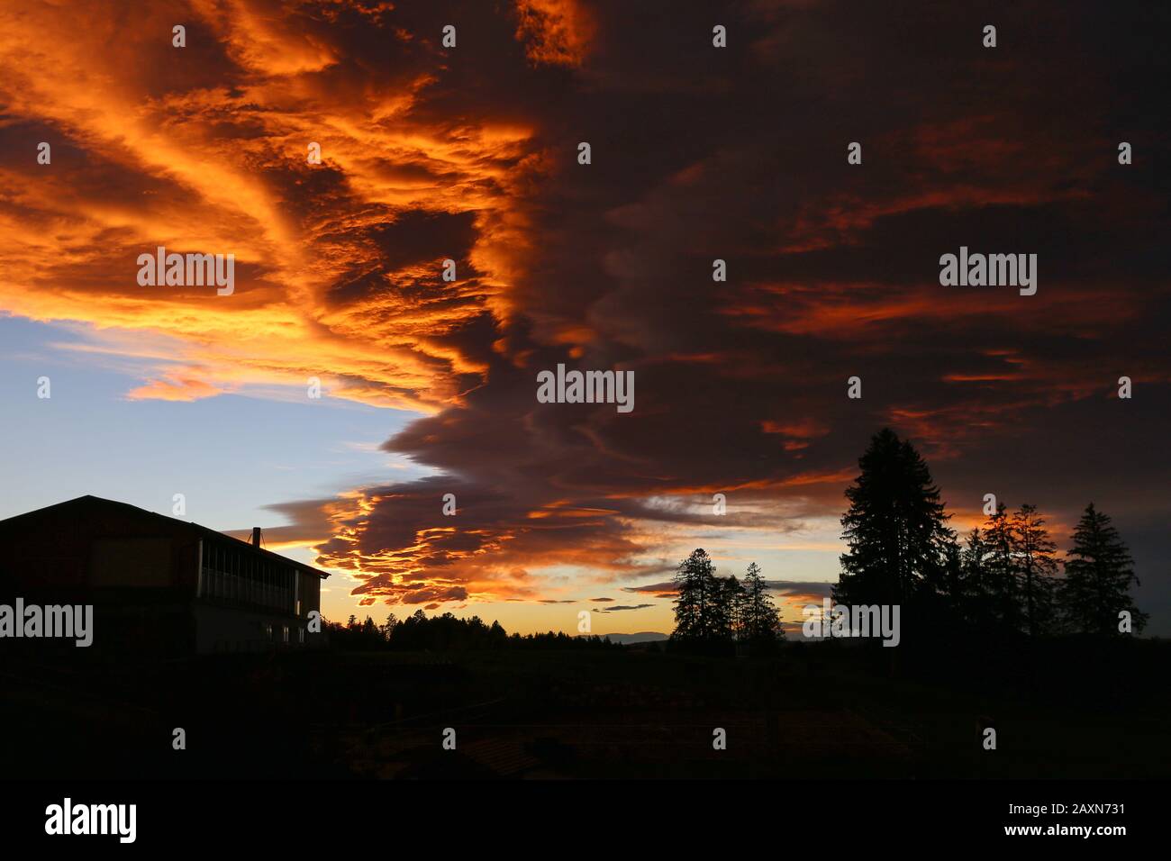 Red evening. The sky is on fire. Amazing clouds.. Dramatic sunset Stock Photo