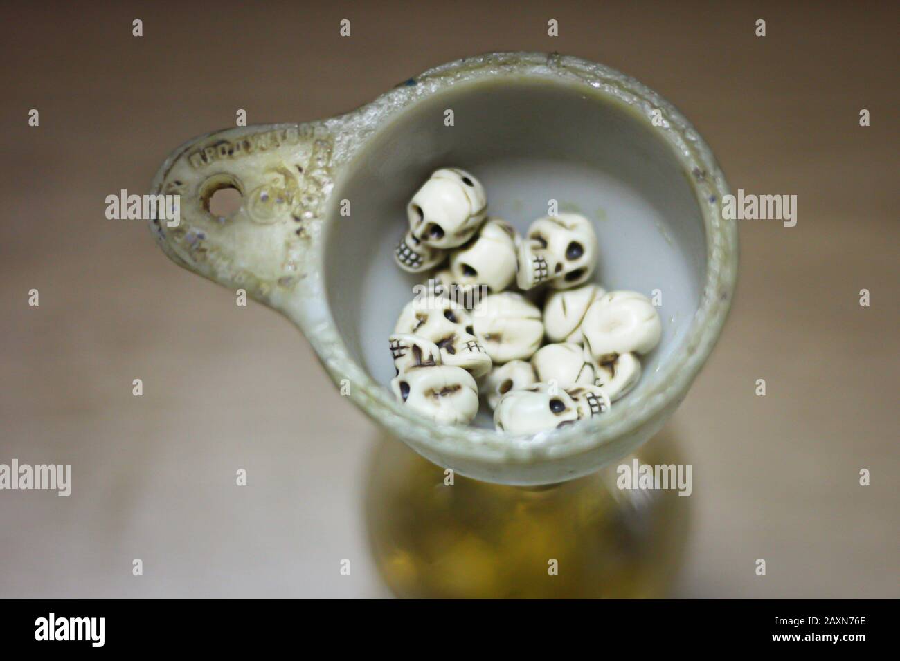 skulls in the watering can on the table Stock Photo