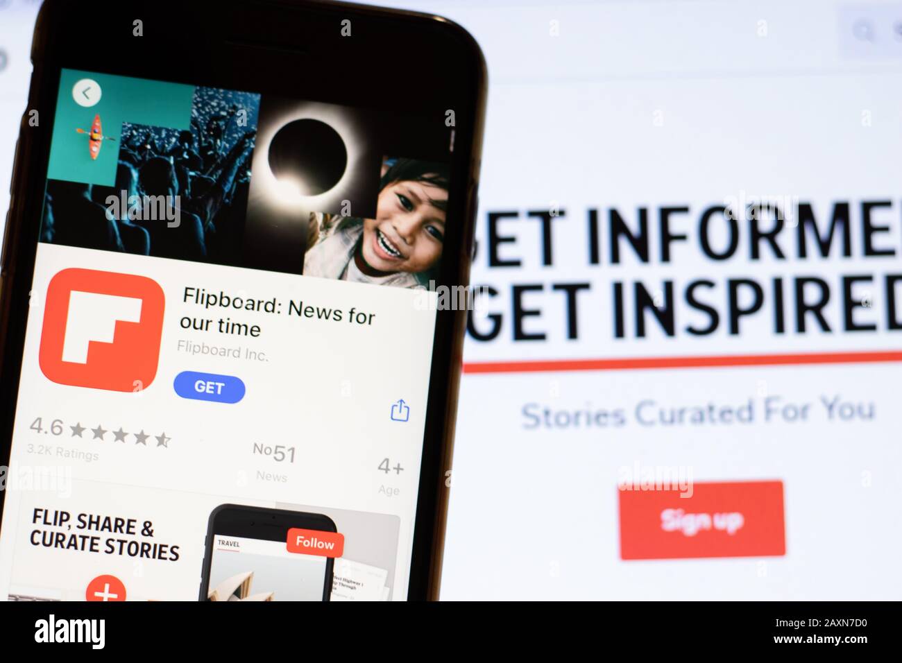 Los Angeles, California, USA - 12 February 2020: Mobile phone with Flipboard icon on screen close up with website on laptop. Blurred background with Stock Photo