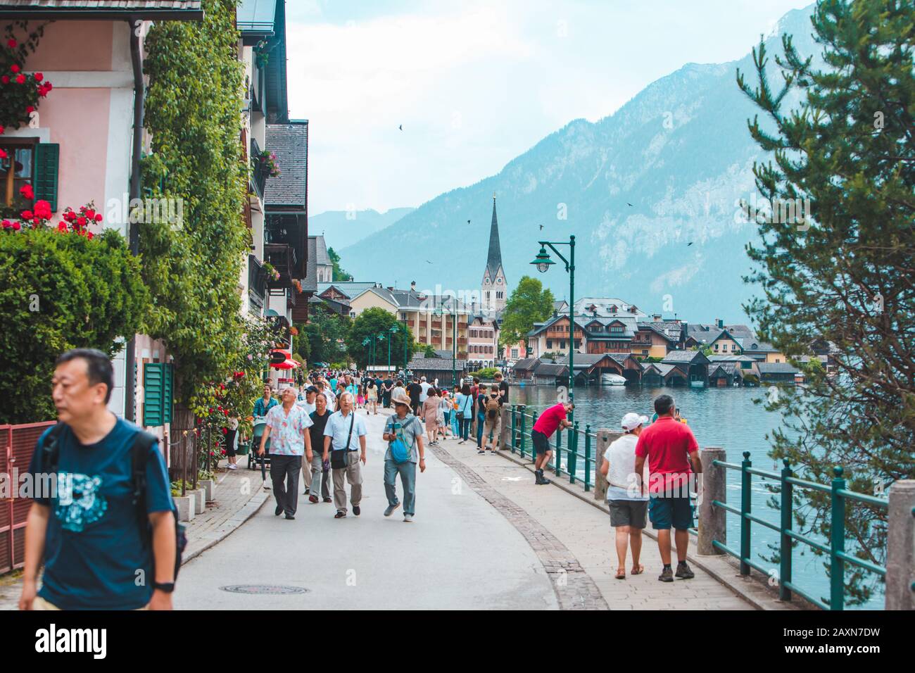Hallstatt, Austria - June 15, 2019: people walking by city quay enjoying the view Stock Photo