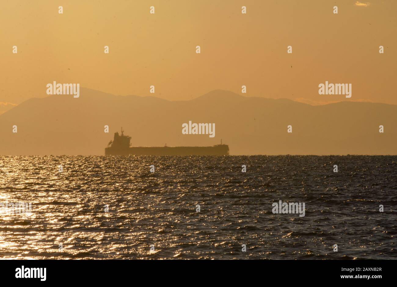 Cargo ship entering the Port of Piraeus in Athens Greece Stock Photo