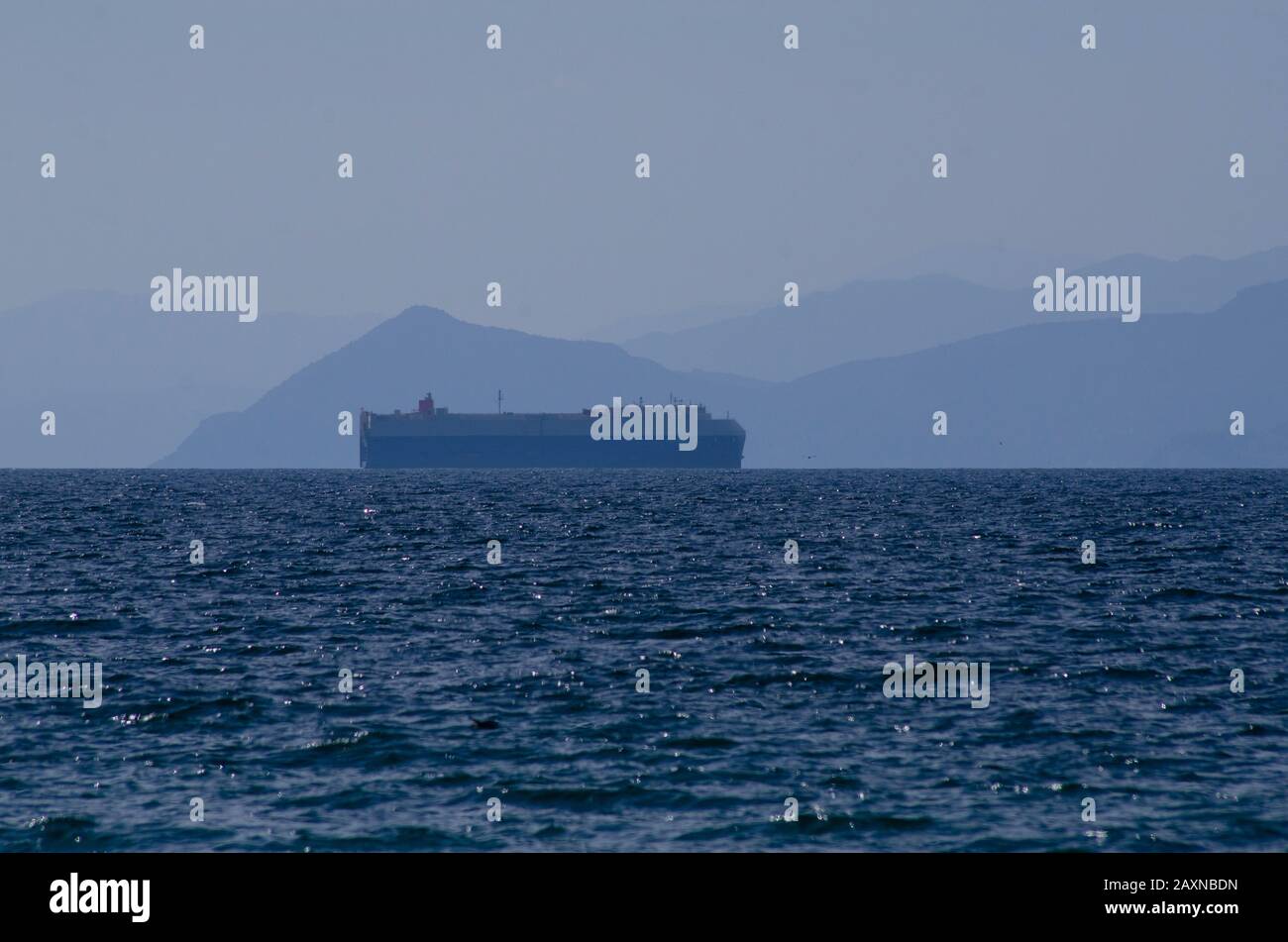 Cargo ship entering the Port of Piraeus in Athens Greece Stock Photo
